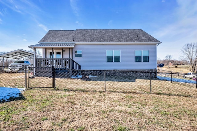 rear view of property featuring a yard and a carport