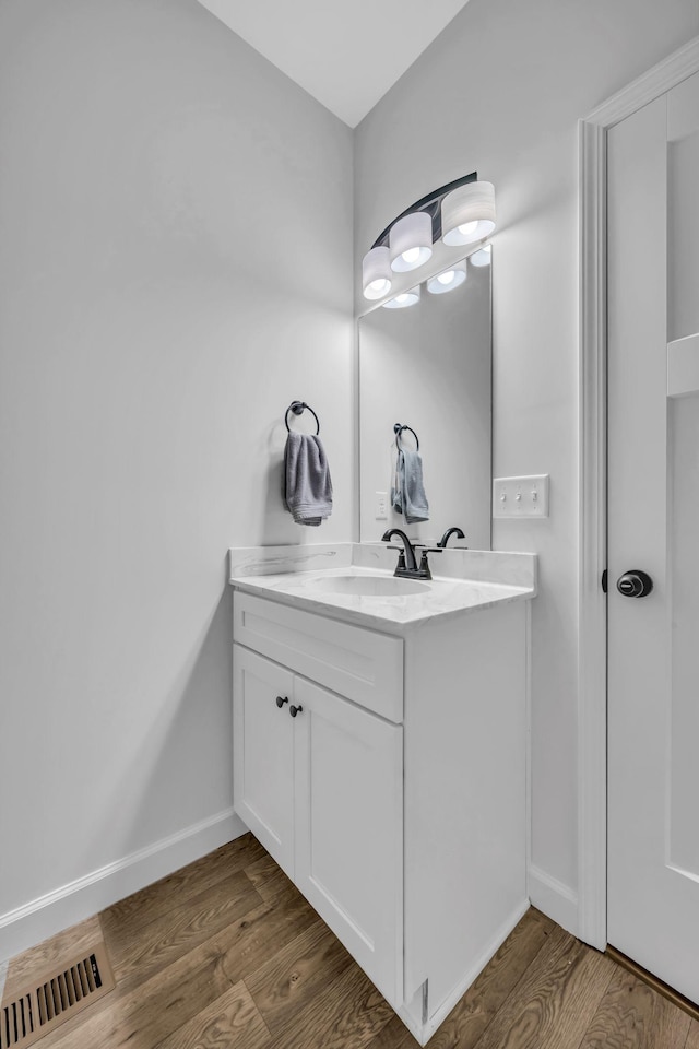 bathroom featuring wood-type flooring and vanity