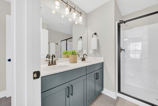 bathroom featuring tile patterned floors, an enclosed shower, and vanity