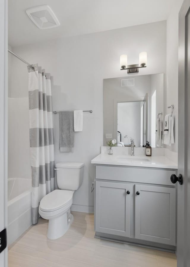 full bathroom with toilet, shower / bath combo, and vanity