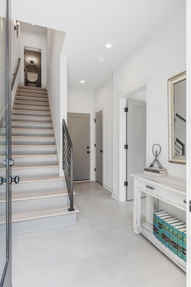 staircase featuring concrete floors