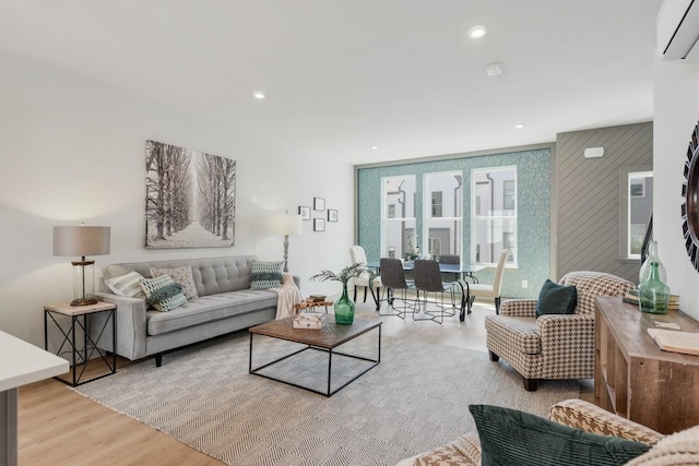 living room with light wood-type flooring and a wall mounted AC