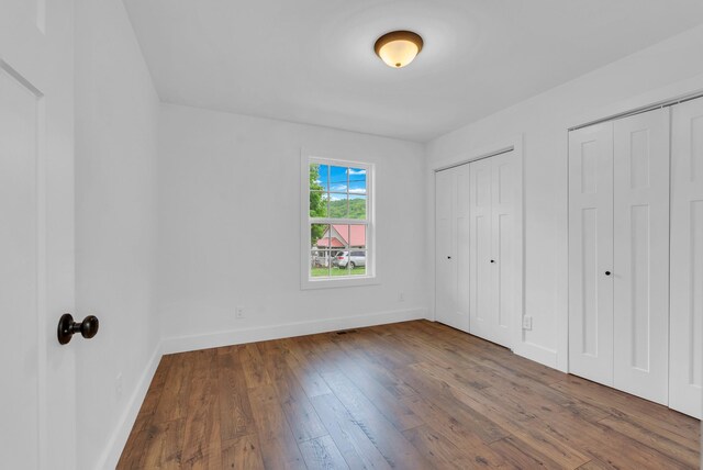 286 Wilhite, Doyle, TN 38559 - unfurnished bedroom with hardwood / wood-style flooring, two closets, and baseboards