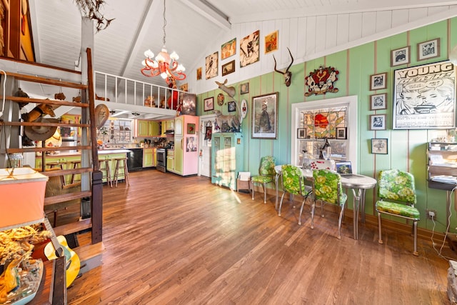 living room with high vaulted ceiling, an inviting chandelier, hardwood / wood-style flooring, and beam ceiling