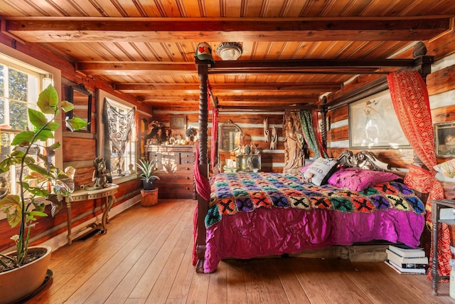 bedroom featuring hardwood / wood-style flooring, beam ceiling, and wood ceiling