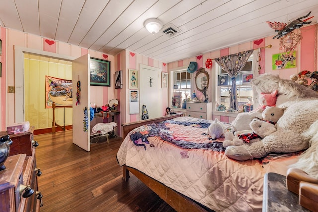 bedroom with wooden ceiling and dark wood-type flooring