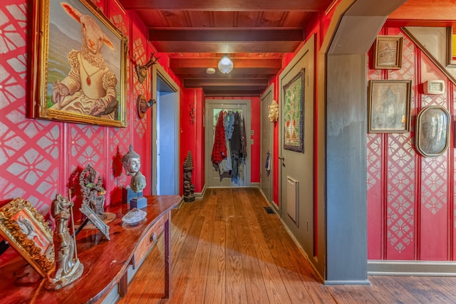 hallway featuring hardwood / wood-style flooring, beam ceiling, and wood ceiling