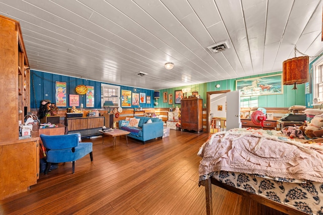 bedroom featuring wood walls, wood-type flooring, and wood ceiling