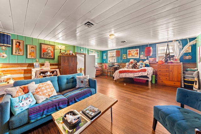 bedroom with wood ceiling, hardwood / wood-style floors, and wooden walls