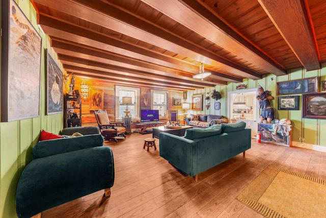 living room featuring beam ceiling, wooden ceiling, and hardwood / wood-style flooring