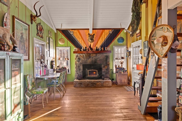 living room featuring wood ceiling, lofted ceiling with beams, a wealth of natural light, and hardwood / wood-style flooring