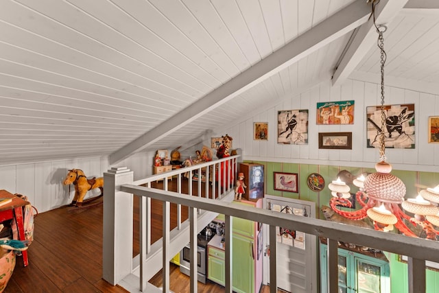 corridor featuring lofted ceiling with beams, wood walls, and hardwood / wood-style flooring