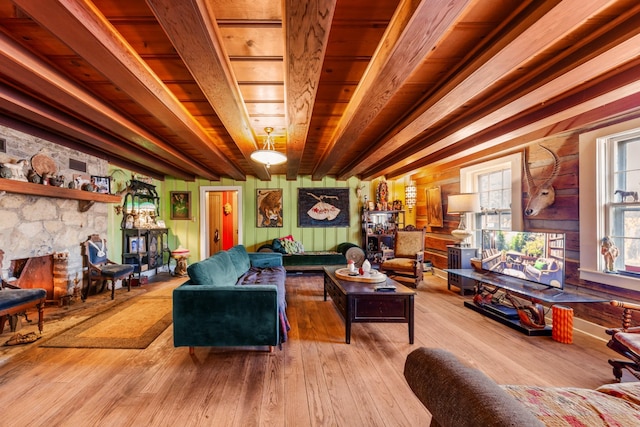 living room with hardwood / wood-style flooring and a stone fireplace