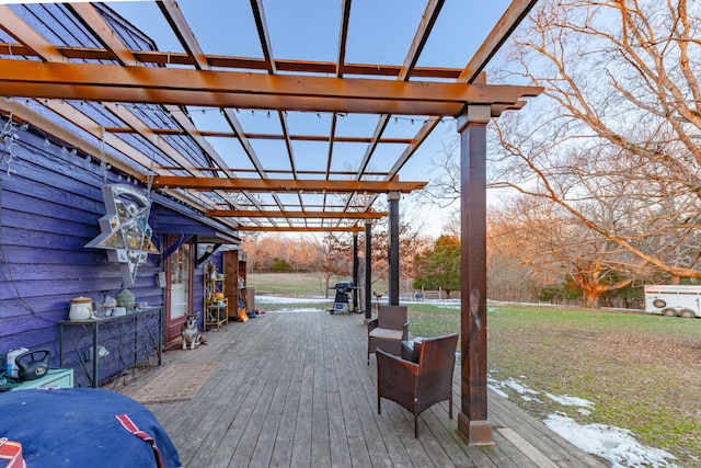 wooden terrace featuring a yard and a pergola