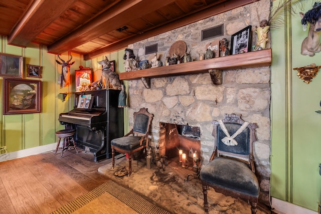 interior space featuring wooden ceiling, a fireplace, hardwood / wood-style flooring, and beam ceiling