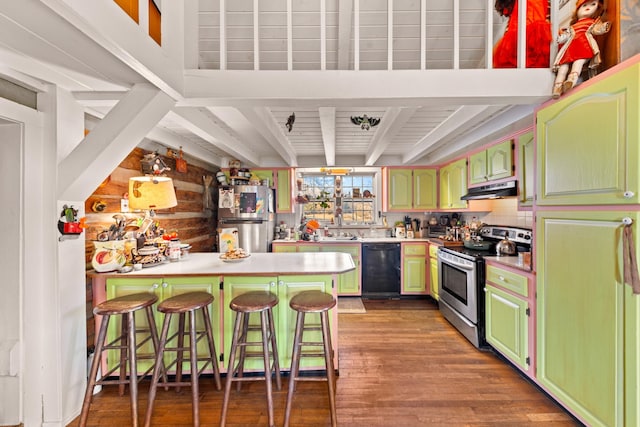 kitchen featuring beamed ceiling, rustic walls, a kitchen bar, kitchen peninsula, and appliances with stainless steel finishes