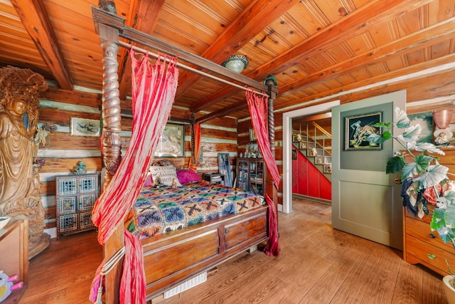 bedroom with wood walls, wooden ceiling, wood-type flooring, and beamed ceiling