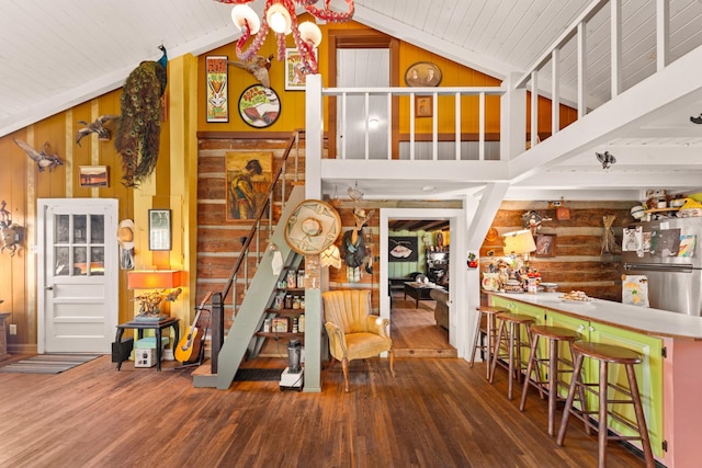 staircase featuring high vaulted ceiling and wood-type flooring