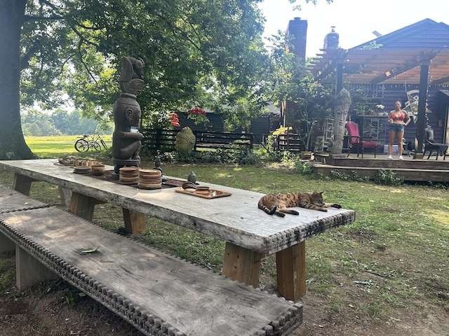 surrounding community featuring a lawn and a deck