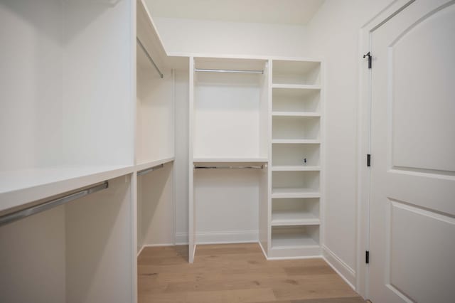 spacious closet with light hardwood / wood-style floors