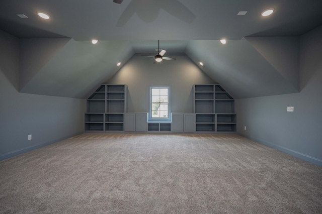 additional living space featuring lofted ceiling, built in features, ceiling fan, and carpet flooring