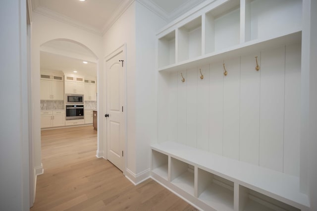 mudroom with ornamental molding and light hardwood / wood-style floors