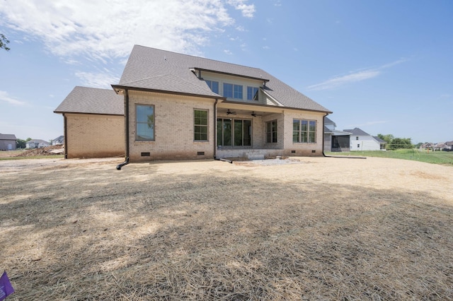 back of property with ceiling fan