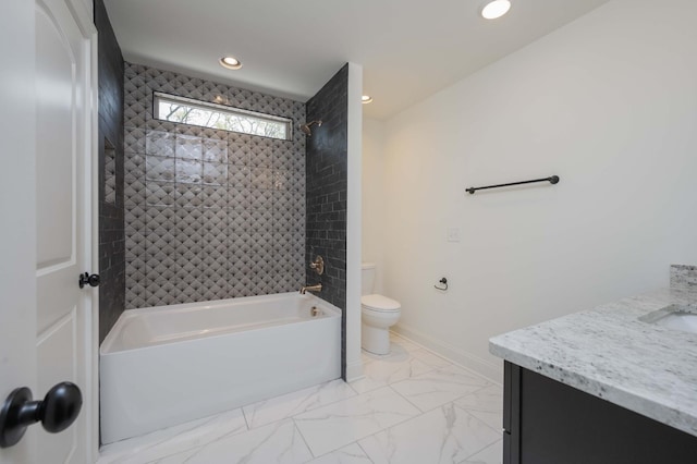 full bathroom with tiled shower / bath, vanity, and toilet