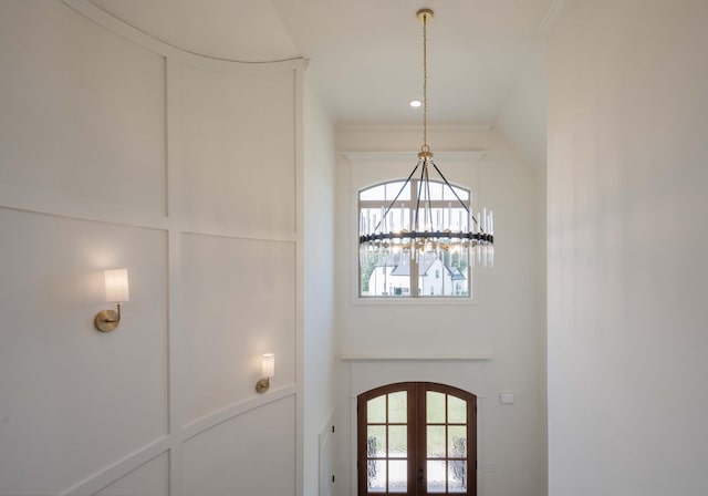 details featuring french doors, an inviting chandelier, and ornamental molding