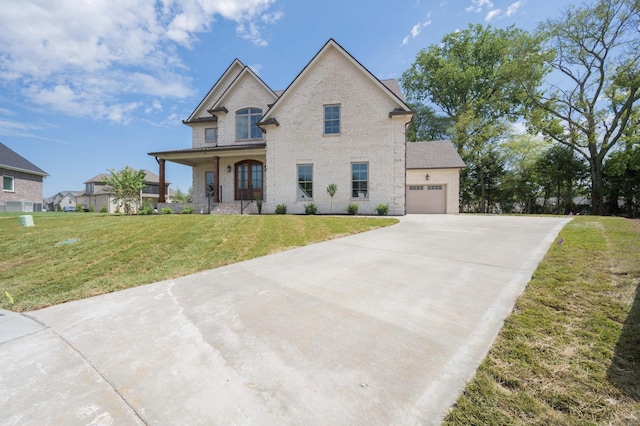 view of front of home with a porch, a front yard, and a garage