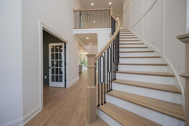 staircase with hardwood / wood-style floors