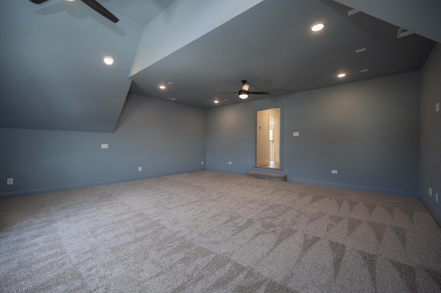 interior space featuring ceiling fan, lofted ceiling, and carpet flooring