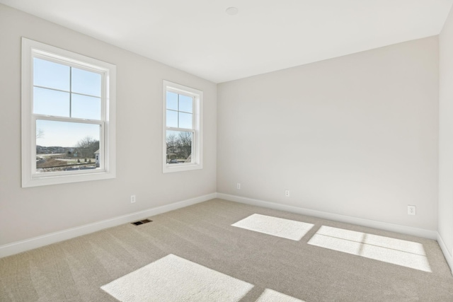 unfurnished room featuring carpet