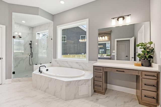 bathroom featuring a wealth of natural light, independent shower and bath, and vanity