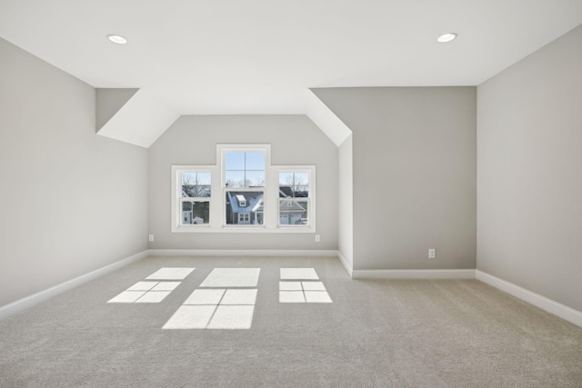 bonus room with light carpet and lofted ceiling