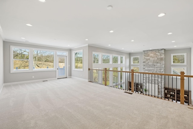 carpeted spare room featuring crown molding