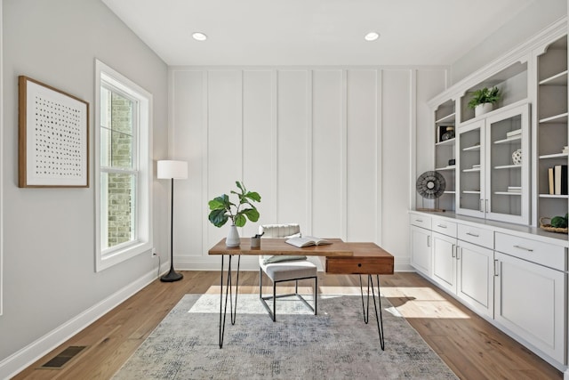 office with light wood-type flooring