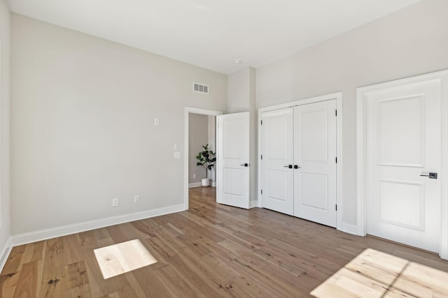 unfurnished bedroom with hardwood / wood-style floors