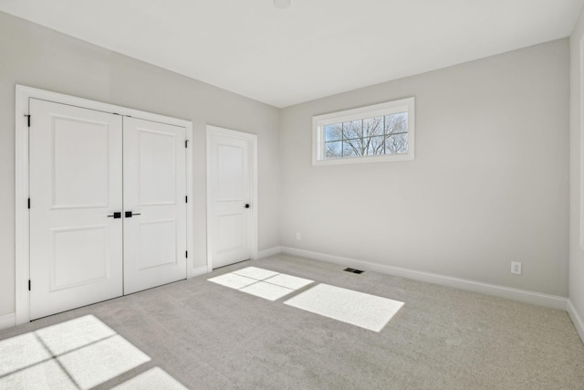 unfurnished bedroom with light carpet