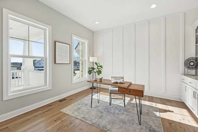 office with light hardwood / wood-style flooring