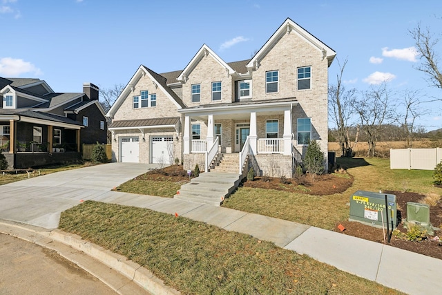 view of front of home with a porch, a garage, and a front yard