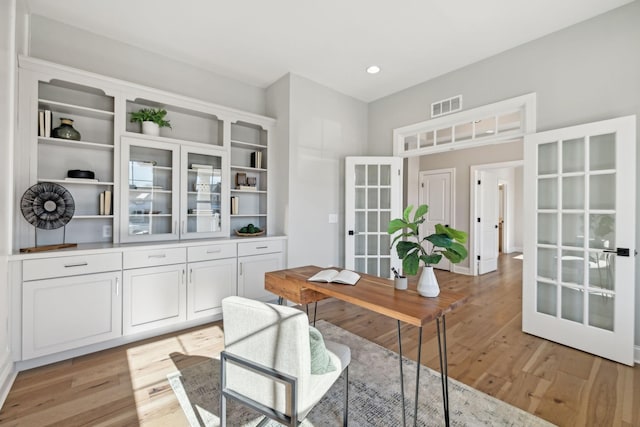 office featuring french doors and light hardwood / wood-style floors