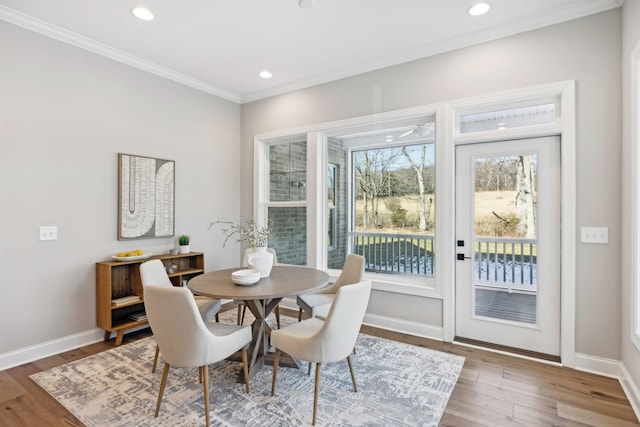 dining room with hardwood / wood-style floors and ornamental molding