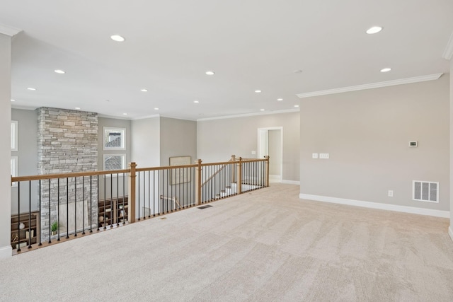 empty room featuring light carpet and crown molding