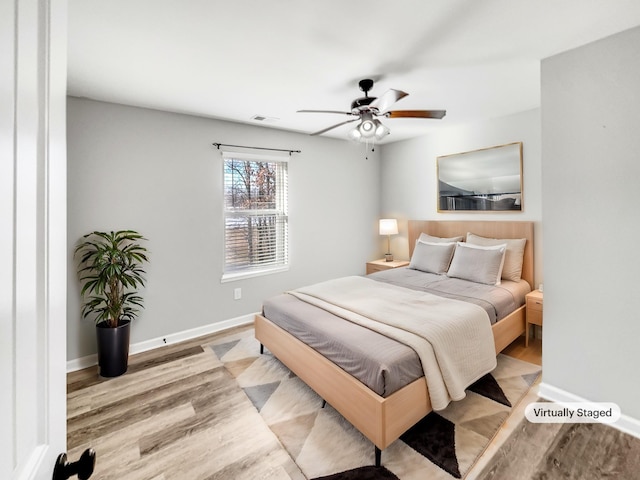 bedroom featuring light wood-type flooring and ceiling fan