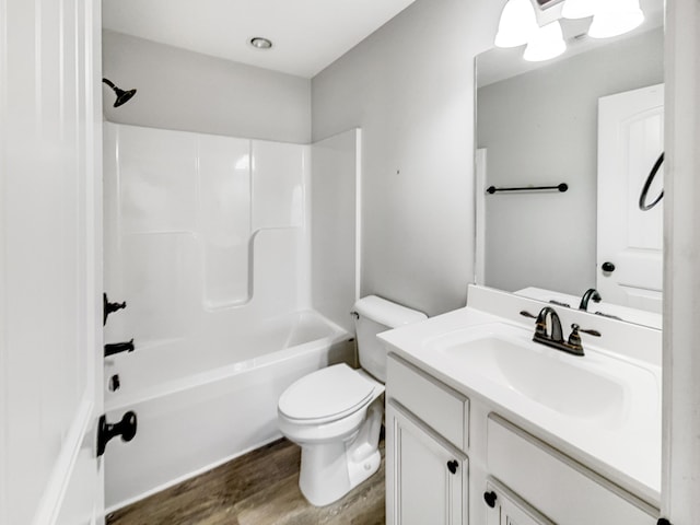 full bathroom with toilet, shower / washtub combination, wood-type flooring, and vanity