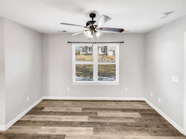 spare room with hardwood / wood-style floors and ceiling fan