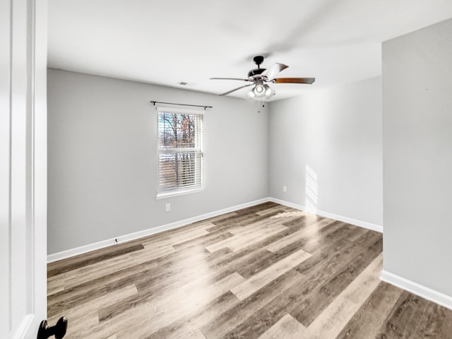 empty room with ceiling fan and wood-type flooring