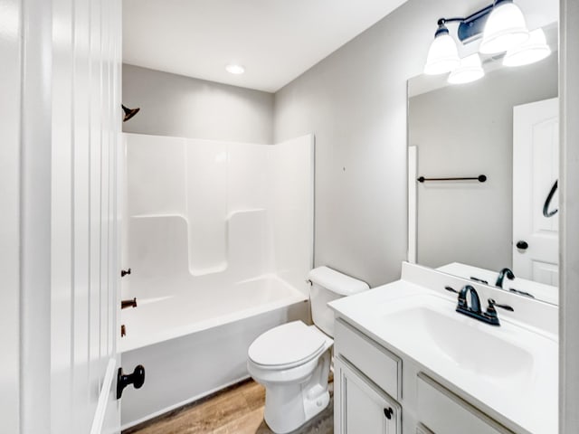 full bathroom with bathtub / shower combination, toilet, vanity, and wood-type flooring