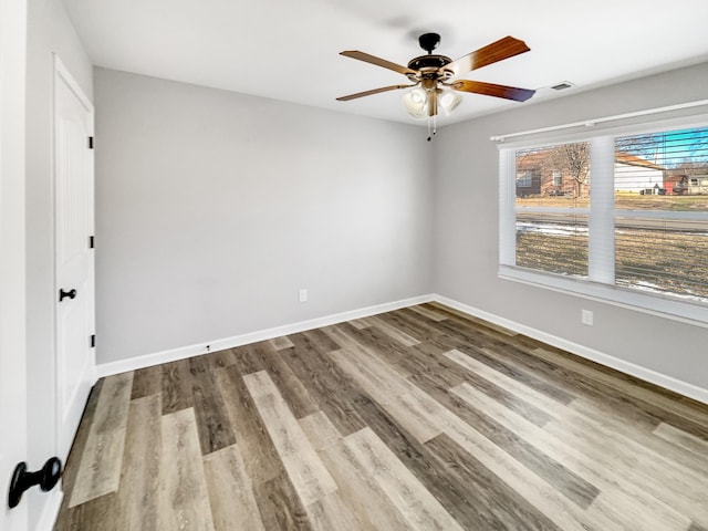 unfurnished room with ceiling fan and hardwood / wood-style floors